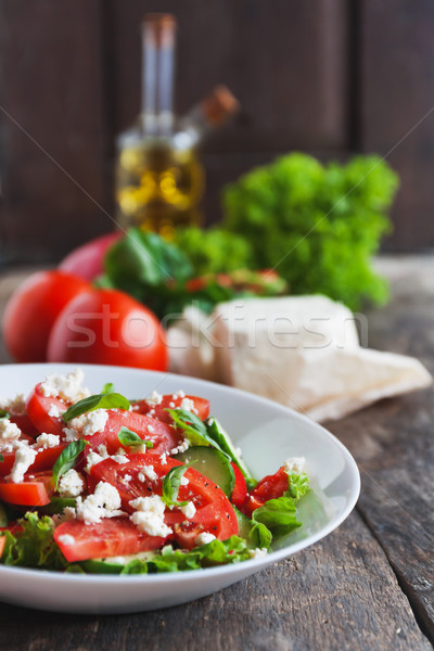 Shopska salad in a white plate on a wooden background, a number  Stock photo © TanaCh