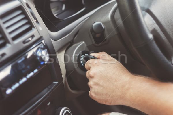 man's hand starts a car with the key in retro toning Stock photo © TanaCh