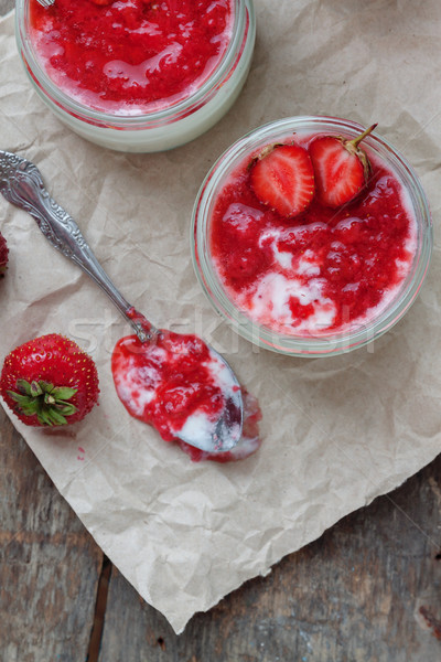 Stock photo: Yogurt with jam sauce in glass and a bucket with fresh strawberr