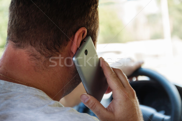 Homme parler téléphone portable conduite voiture téléphone [[stock_photo]] © TanaCh