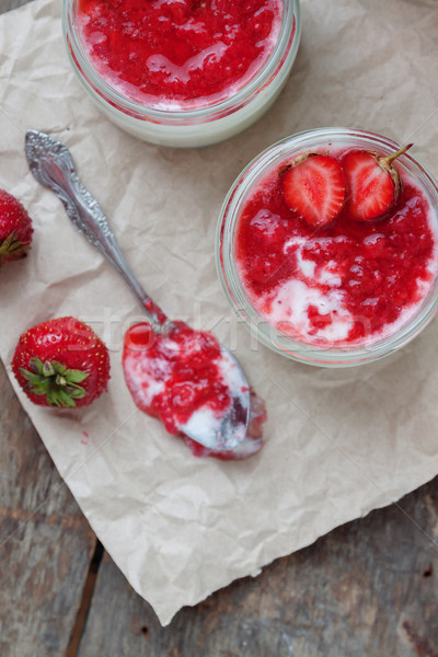 Yogurt with jam sauce in glass and a bucket with fresh strawberr Stock photo © TanaCh