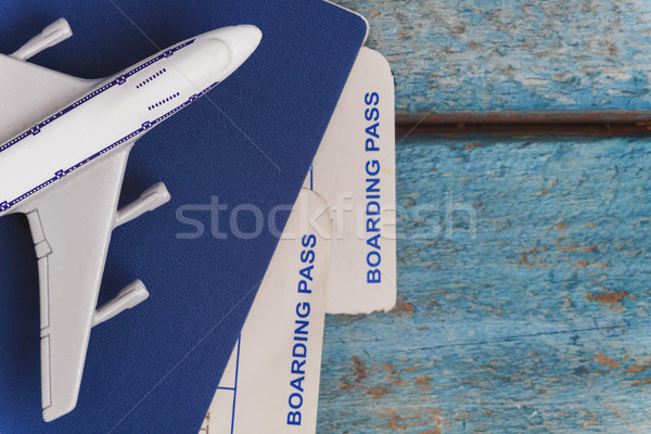 airplane on a passport with air tickets, close-up, on a wooden b Stock photo © TanaCh