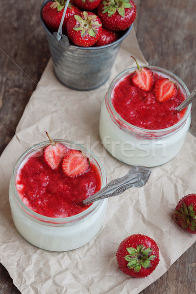 Yogurt with jam sauce in glass and a bucket with fresh strawberr Stock photo © TanaCh