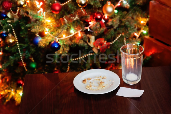 empty glass from milk and crumbs from cookies for Santa Claus un Stock photo © TanaCh