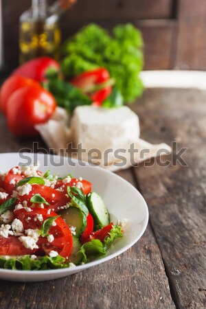 Shopska salad in a white plate on a wooden background, a number  Stock photo © TanaCh