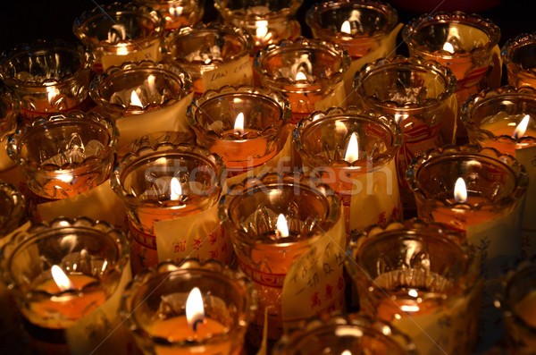 Temple candles in transparent chandeliers Stock photo © tang90246