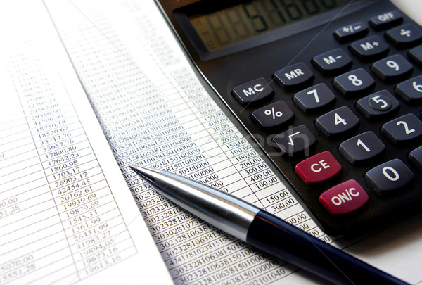 Office table with calculator, pen and accounting document   Stock photo © tannjuska