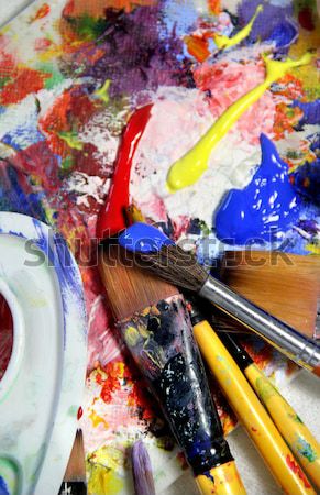 Art palette and mix of brushes Stock photo © tannjuska