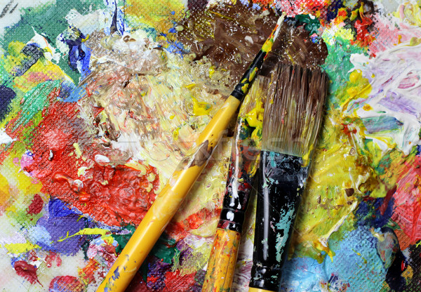 Beautiful vivid art palette and mix of paintbrushes  Stock photo © tannjuska