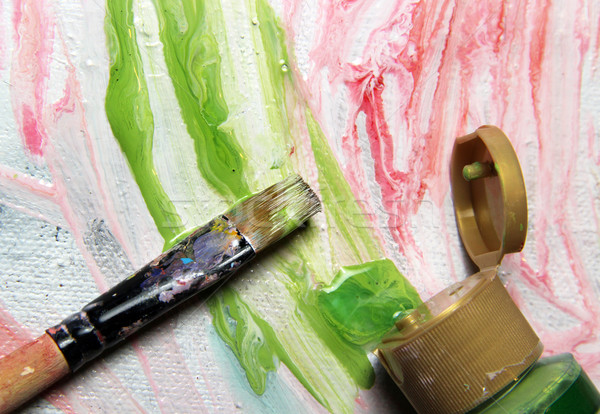 Art palette, paintbrushes and picture with flowers Stock photo © tannjuska