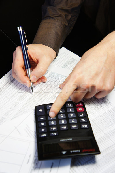 Office table with calculator, pen and accounting document   Stock photo © tannjuska