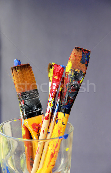 Mix of paintbrushes stained with paints  Stock photo © tannjuska