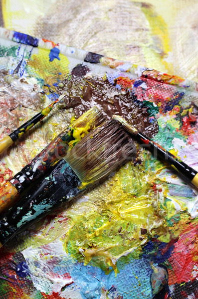 Beautiful vivid art palette and mix of paintbrushes  Stock photo © tannjuska