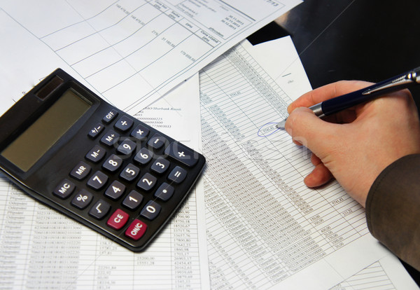 Office table with calculator, pen and accounting document   Stock photo © tannjuska