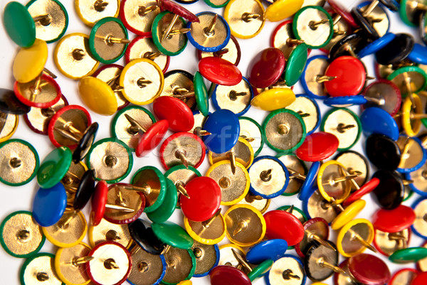 colorful thumbtacks goes to pieces on white background Stock photo © tarczas