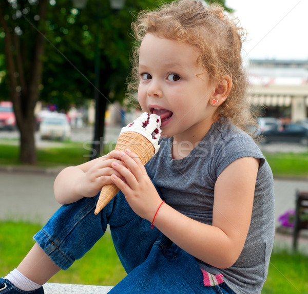 Happy girl with ice cream outdoors Stock photo © TarikVision