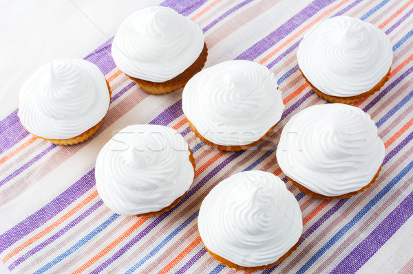 Birthday cupcakes with white whipped cream swirl, top view Stock photo © TasiPas
