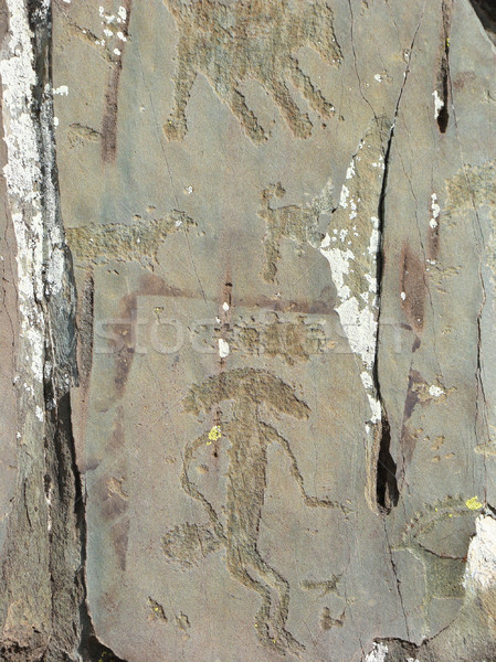 Mythical humanoid creature petroglyph carved in rocks Stock photo © TasiPas