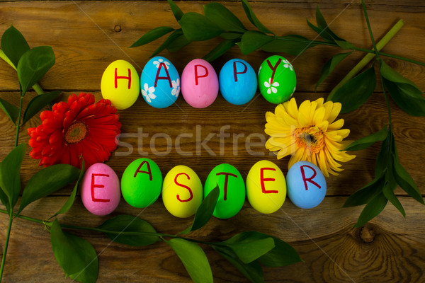 Easter eggs on a dark wooden background Stock photo © TasiPas
