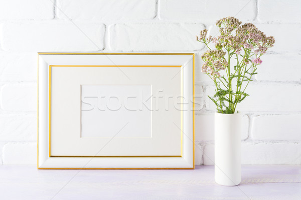Gold decorated landscape frame mockup with wild creamy pink flow Stock photo © TasiPas
