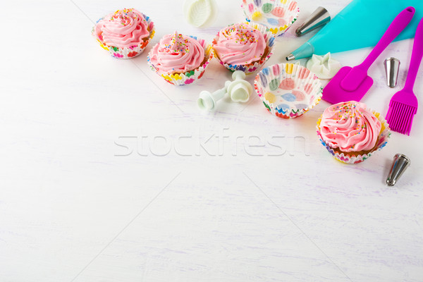 Pink cupcakes  and cookware invitation background Stock photo © TasiPas