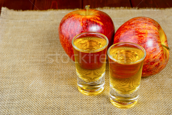 Two schnapps drinks and red apples Stock photo © TasiPas