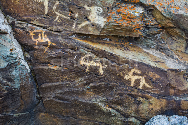 Hunting scenes prehistorical petroglyphs  Stock photo © TasiPas