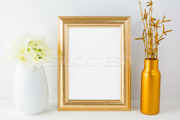 Gold frame mockup with golden vase and ivory hydrangea Stock photo © TasiPas