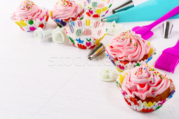 Cookware and pink birthday cupcakes  Stock photo © TasiPas