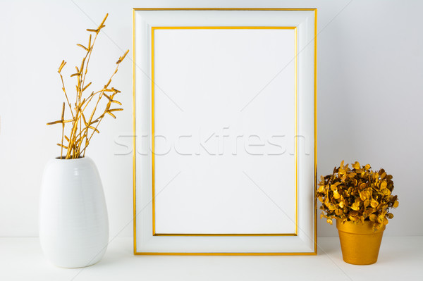Frame mockup with white vase and golden flower pot Stock photo © TasiPas