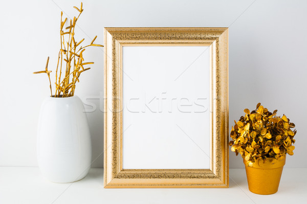 Gold fame mockup with white vase and golden flowerpot Stock photo © TasiPas