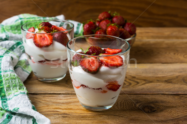 Layered strawberries dessert with cream cheese on rustic wooden  Stock photo © TasiPas