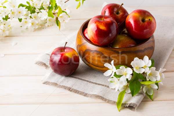 Stock photo: Fresh apples in the wooden bowl and apple blossom