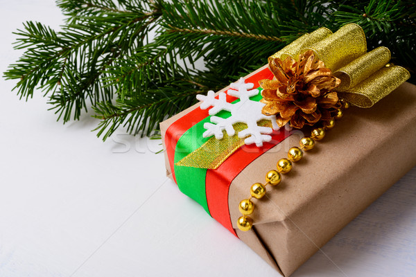 Stock photo: Kraft paper wrapping Christmas gift decorated with snowflake