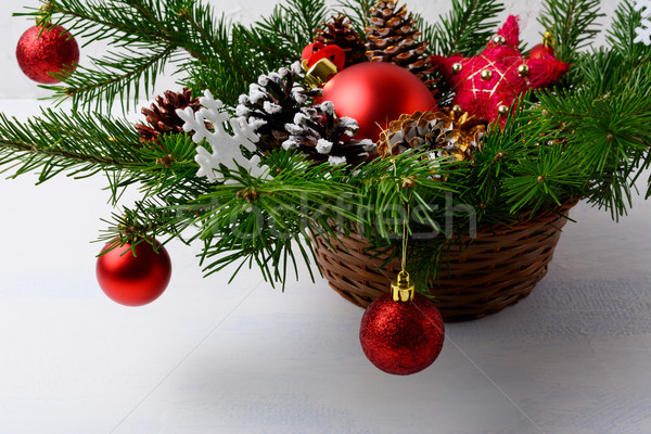 Christmas red ornaments and snowy decorated pine cone table cent Stock photo © TasiPas