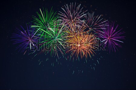 Pink purpe blue green fireworks over night sky Stock photo © TasiPas