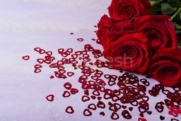 Stock photo: Bunch of burgundy roses on lilac background