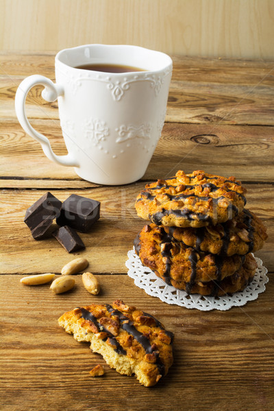 Peanut cookies coating chocolate and tea Stock photo © TasiPas