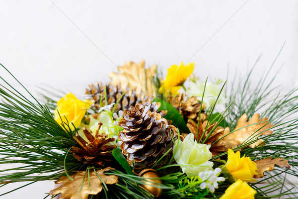 Christmas greenery with golden cones and yellow silk roses  Stock photo © TasiPas