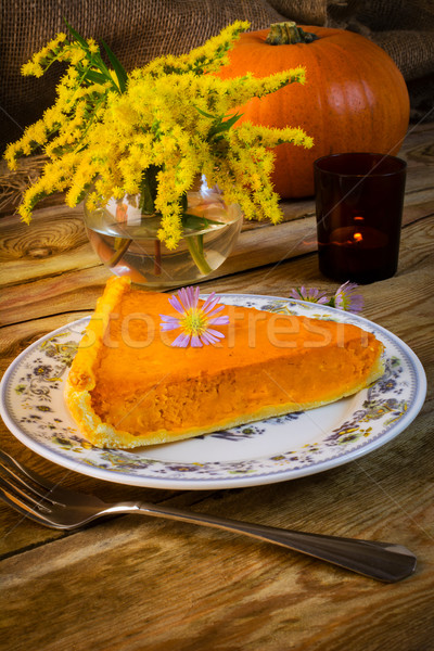 Pumpkin pie slice on the rustic wooden table Stock photo © TasiPas