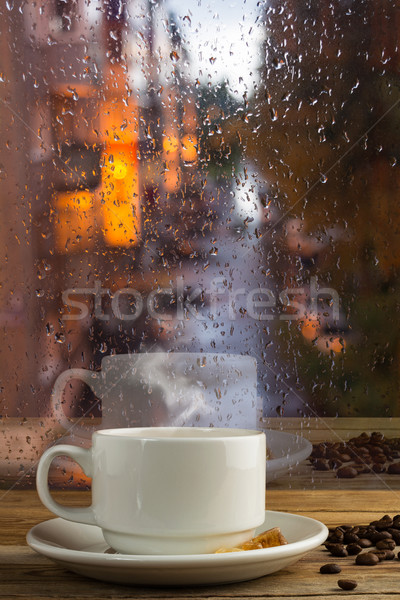 Cup of strong coffee on the rainy window background Stock photo © TasiPas