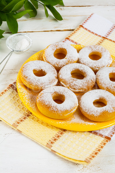 Stock photo: Caster sugar powdered donuts on yellow plate 