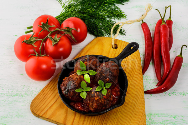 Grilled beef meatballs with chili pepper  served in skillet Stock photo © TasiPas