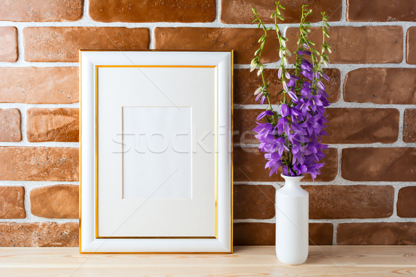 Gold decorated frame mockup with bellflower bouquet exposed bric Stock photo © TasiPas