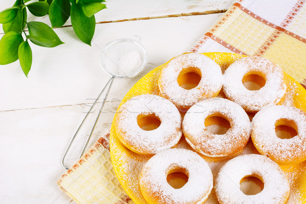 Donuts powdered by caster sugar on checkered napkin Stock photo © TasiPas