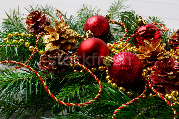 Stock photo: Christmas garland with red ornaments and golden pine cones 