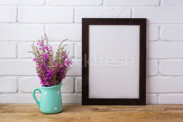 Black brown  frame mockup with maroon purple flowers in mint pit Stock photo © TasiPas