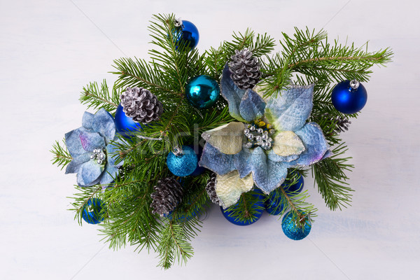 Christmas centerpiece with glitter baubles, blue silk poinsettia Stock photo © TasiPas