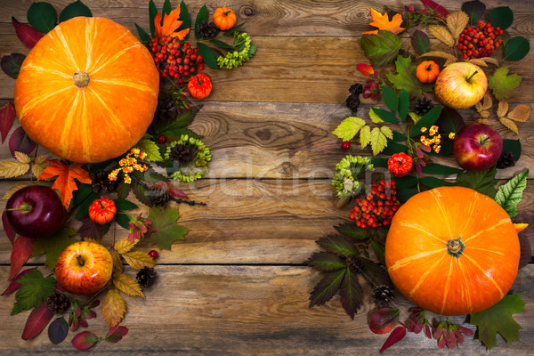 Thanksgiving greeting with leaves and pumpkin on wooden table Stock photo © TasiPas