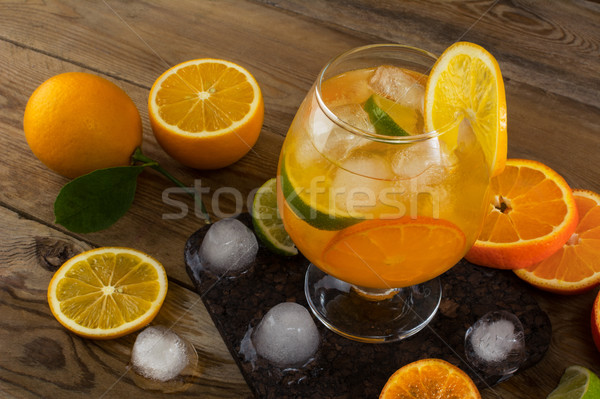 Tropical iced fruit cocktail on wooden table Stock photo © TasiPas